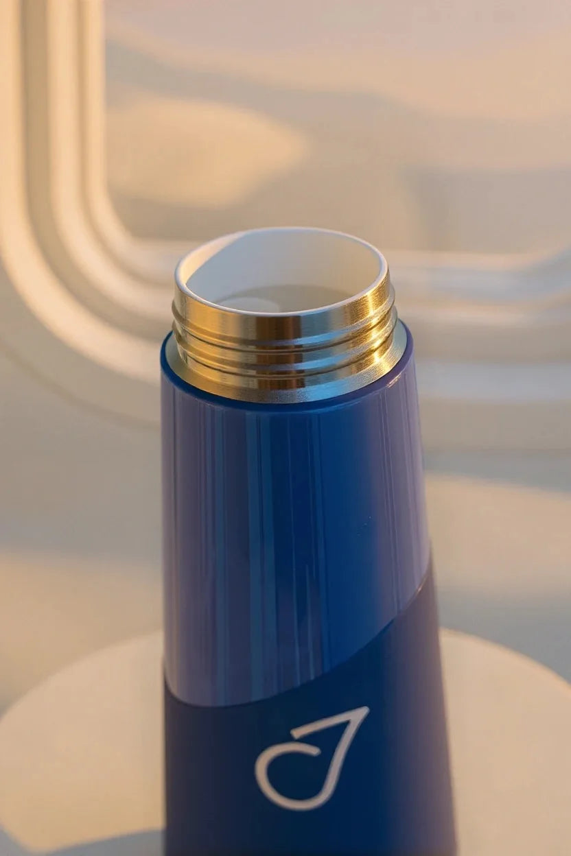 White ceramic interior and blue bottle in warm window light