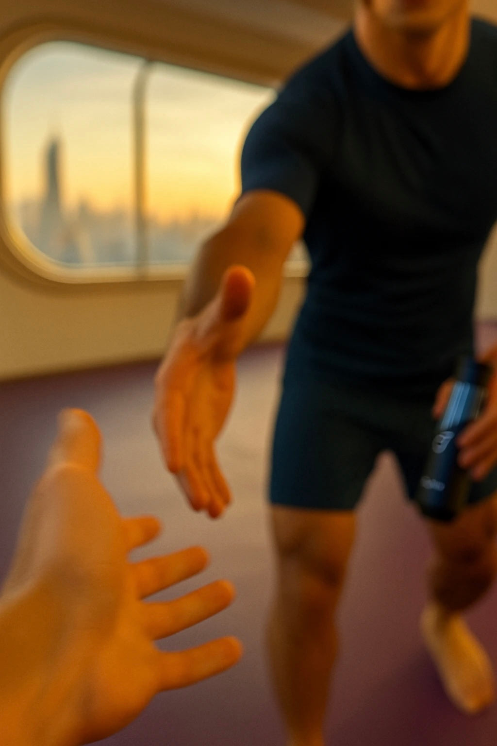 Two people reaching out to each other with a blurred background