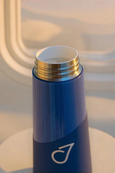 White ceramic interior and blue bottle in warm window light
