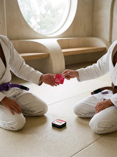 Two grapplers sharing an individually wrapped Energy Strip before training