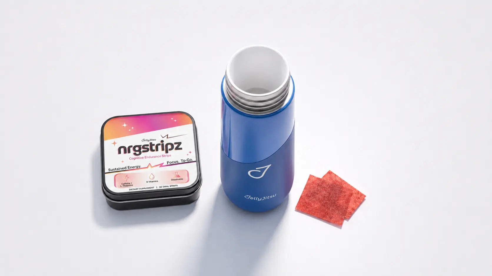 Open navy JellyJitsu Ceramic Training Bottle beside one NRGStripz tin and loose cranberry-red strips on a white studio surface