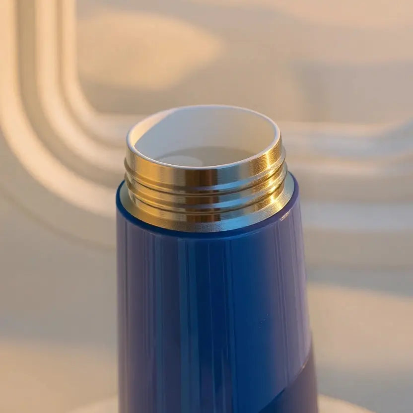 Open Horizon Blue JellyJitsu Ceramic Training Bottle showing the white ceramic-bonded interior