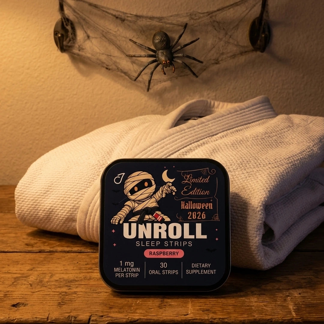 Halloween 2026 Unroll tin beside a folded jiu-jitsu gi